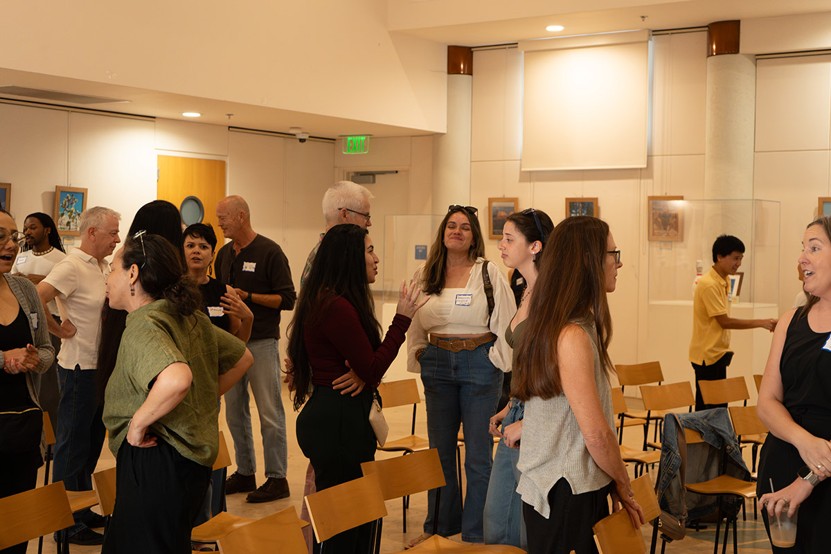people standing networking in a room